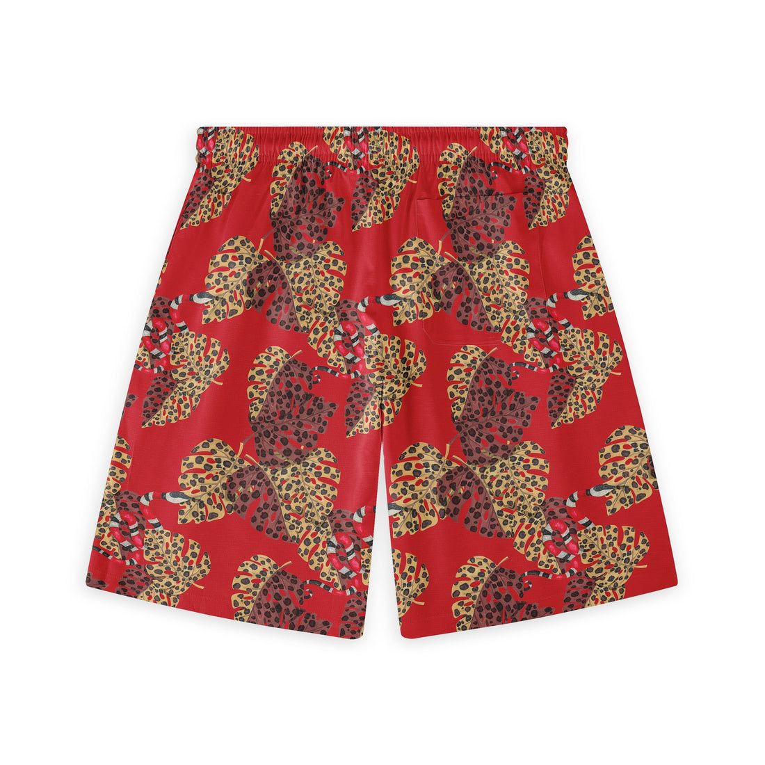 Hawaiian shorts with a red background, adorned with large, leopard-print leaves in yellow and brown tones, and subtle snake elements throughout the design.