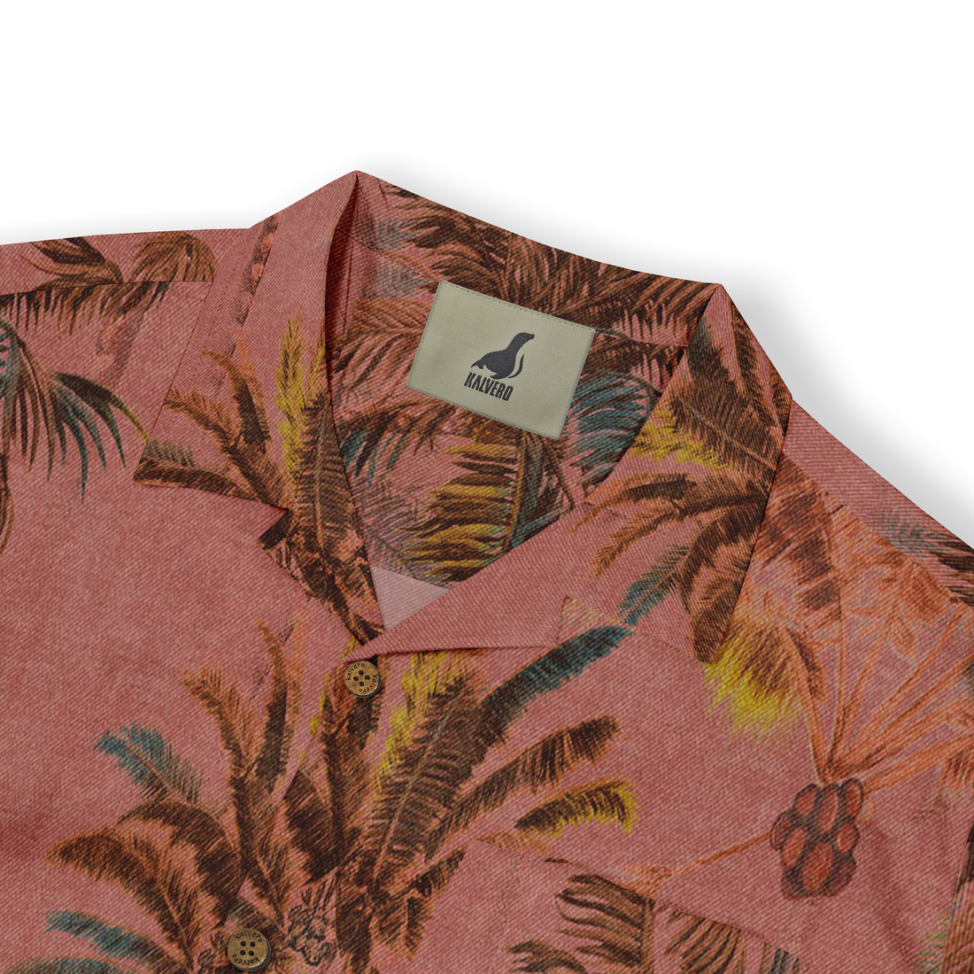 Close-up of a Hawaiian shirt collar, highlighting the reddish fabric with a tropical palm tree print in brown and green tones. The shirt features wooden buttons and the Kalvero brand tag.