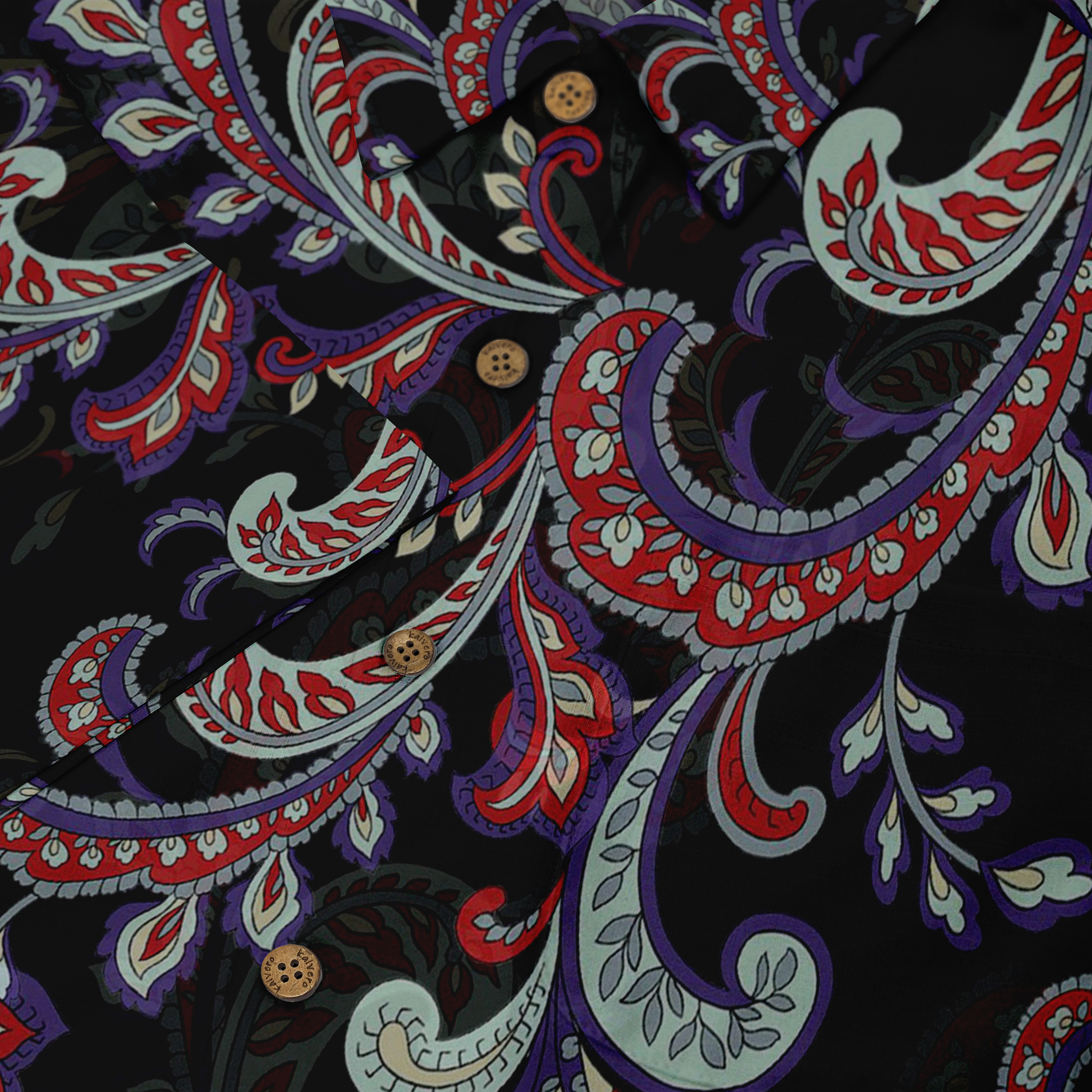 A detailed view of a shirt with a bold paisley pattern in red, purple, and green hues on a black background, accented with wooden buttons.