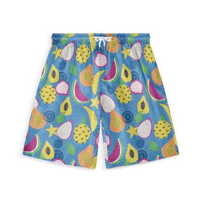 Hawaiian shorts with a playful, colorful tropical fruit pattern on a blue dotted background, featuring pineapples, watermelon, starfruit, and other fruits, perfect for a vibrant summer look.