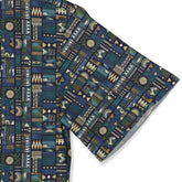 Blue fabric with geometric patterns in green, white, and gold.