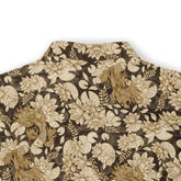 Hawaiian shirt with a dark background and detailed light-colored floral and fish motifs, adding an artistic and natural touch.