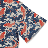 A vibrant fabric featuring red koi fish swimming in blue waves.