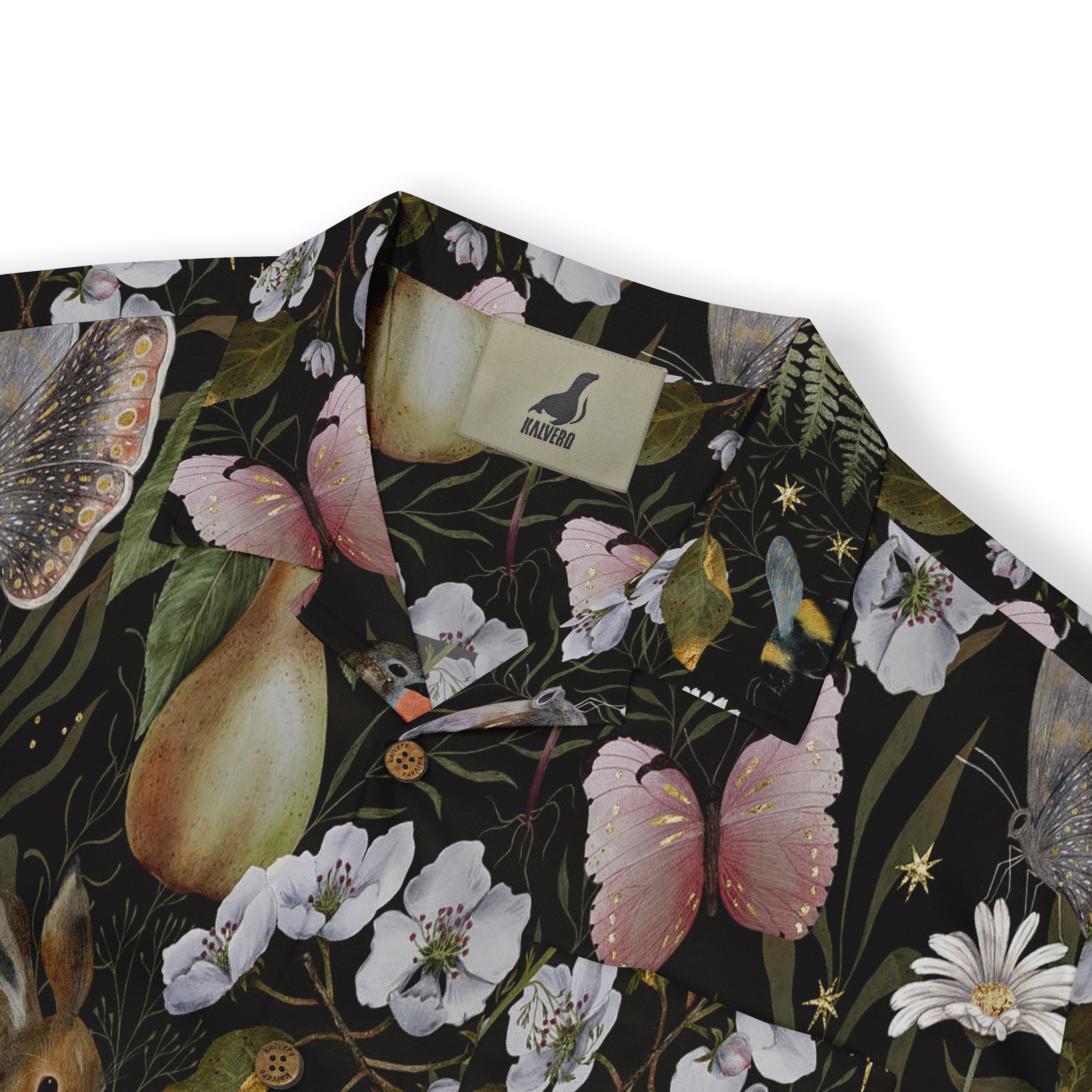 Close-up view of a shirt collar showcasing a whimsical design with butterflies, blossoms, and a pear on a dark background, featuring the Kalvero brand tag.