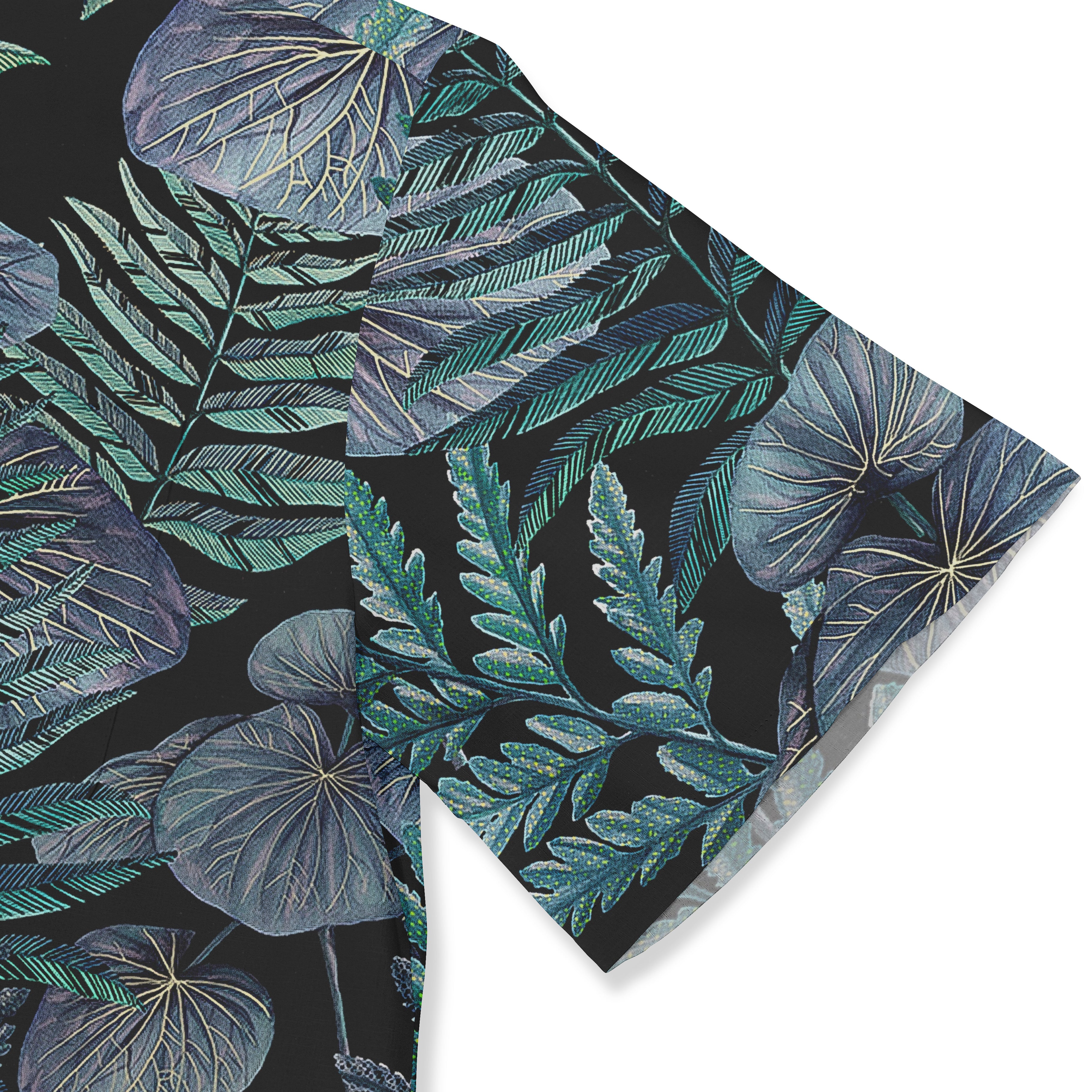 A close-up of the sleeve of a Hawaiian shirt, featuring an intricate design of tropical leaves in various shades of blue and green on a dark background. The details highlight the vibrant leaf patterns, adding a lush, natural feel to the fabric.