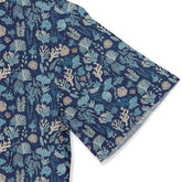 Navy blue fabric with coral and sea plant pattern in light blue.