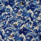 Shirt with a design featuring dynamic ocean waves and leaping dolphins in deep blue and white hues inspired by traditional Japanese wave art close-up