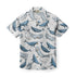 White shirt with blue whale print and brown buttons.