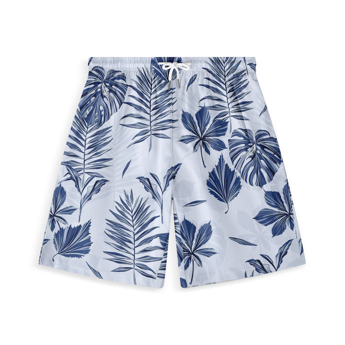 Light blue swim shorts with navy tropical leaf print and white.
