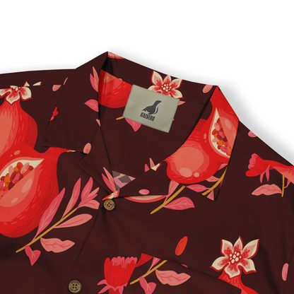 Close-up of a Hawaiian shirt collar with a pomegranate and floral pattern in red and pink tones on a deep burgundy background, featuring brown buttons.