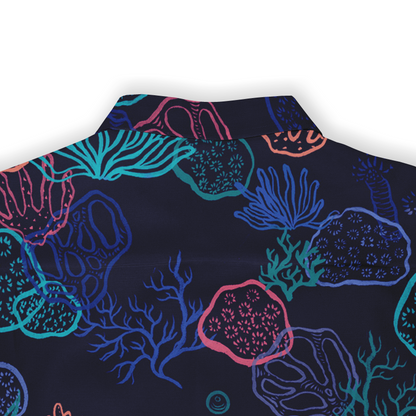 Back collar view of a Hawaiian shirt with a vibrant coral reef pattern in neon colors on a dark background.