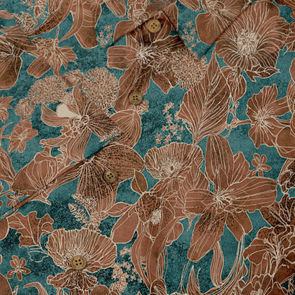 Close-up of a Hawaiian shirt pocket with a floral pattern in brown and teal tones, featuring brown buttons.