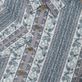 Blue and white patterned fabric with paisley and geometric designs.