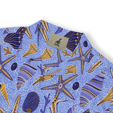 Hawaiian shirt with blue and gold starfish, seashells, and swirling ocean patterns, featuring Kalvero branding.