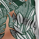 A Hawaiian shirt featuring green and white striped botanical patterns, exuding a fresh and natural style.