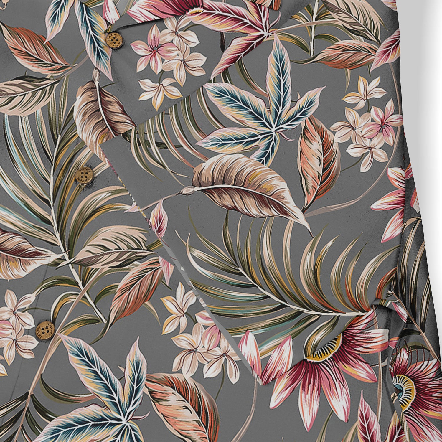 This close-up emphasizes the detailed tropical floral and foliage patterns on a gray background, showcasing the intricate design and vibrant colors that give the shirt a sophisticated and nature-inspired look.