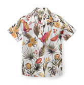 This shirt features a lively tropical design with colorful parrots, palm leaves, and fruits, perfect for adding a vibrant touch to your summer wardrobe. Ideal for vacations or casual beach days.