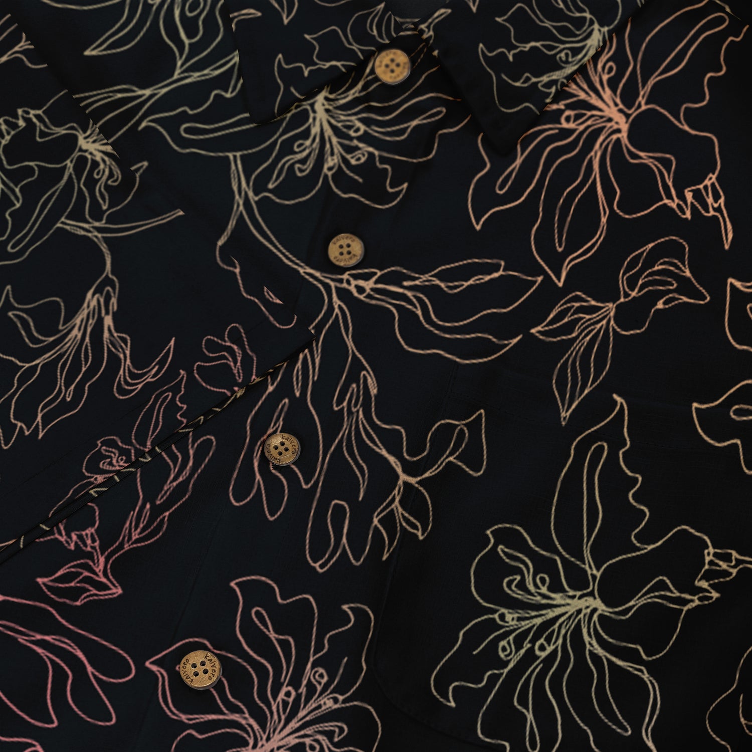 This close-up image showcases a delicate floral pattern on a dark shirt, with light lines creating a refined, elegant contrast against the fabric.