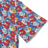 Colorful floral fabric with red, blue, yellow flowers on white.