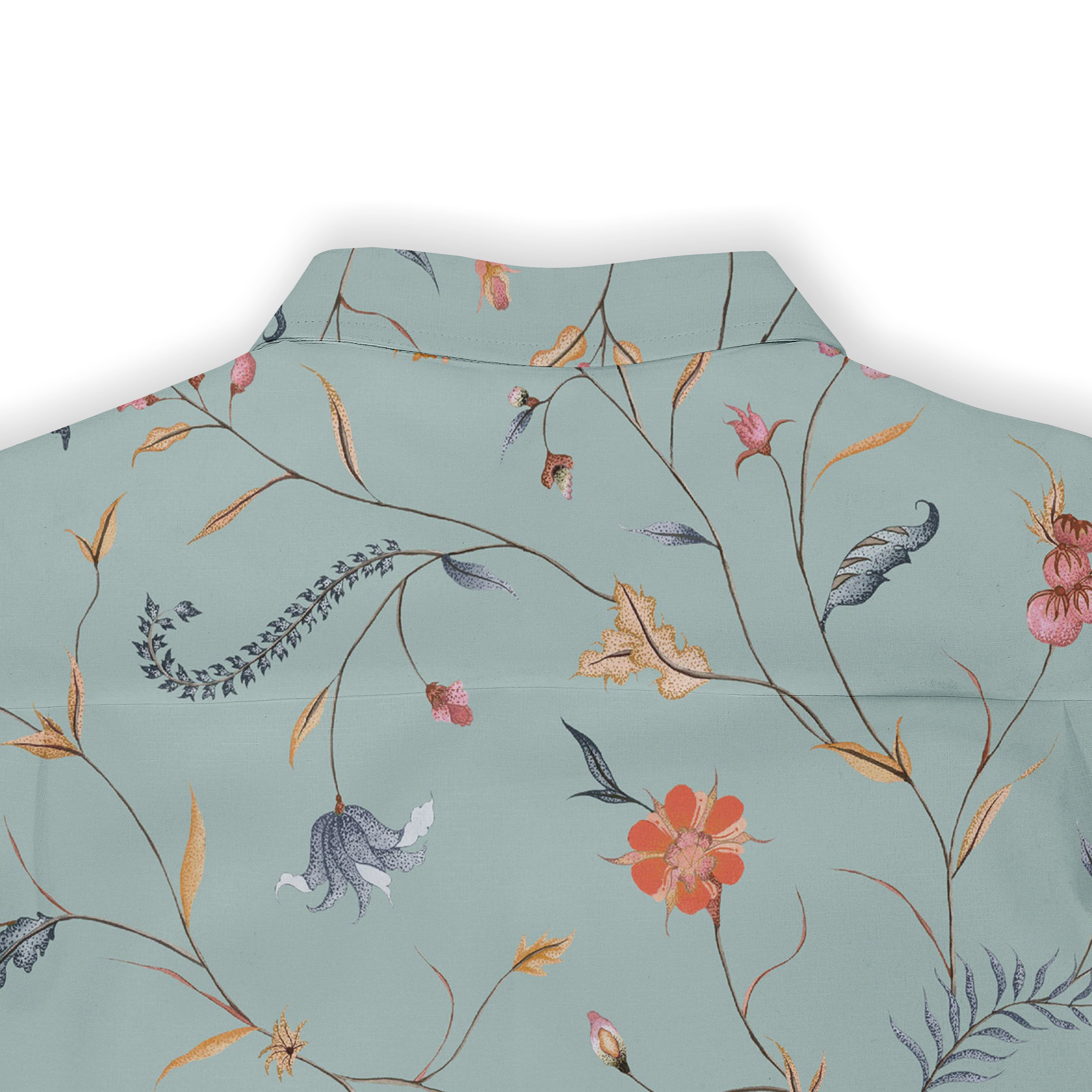 Back view of a light green shirt featuring an intricate floral and botanical print with vibrant flowers, leaves, and delicate branches, showcasing a nature-inspired design.