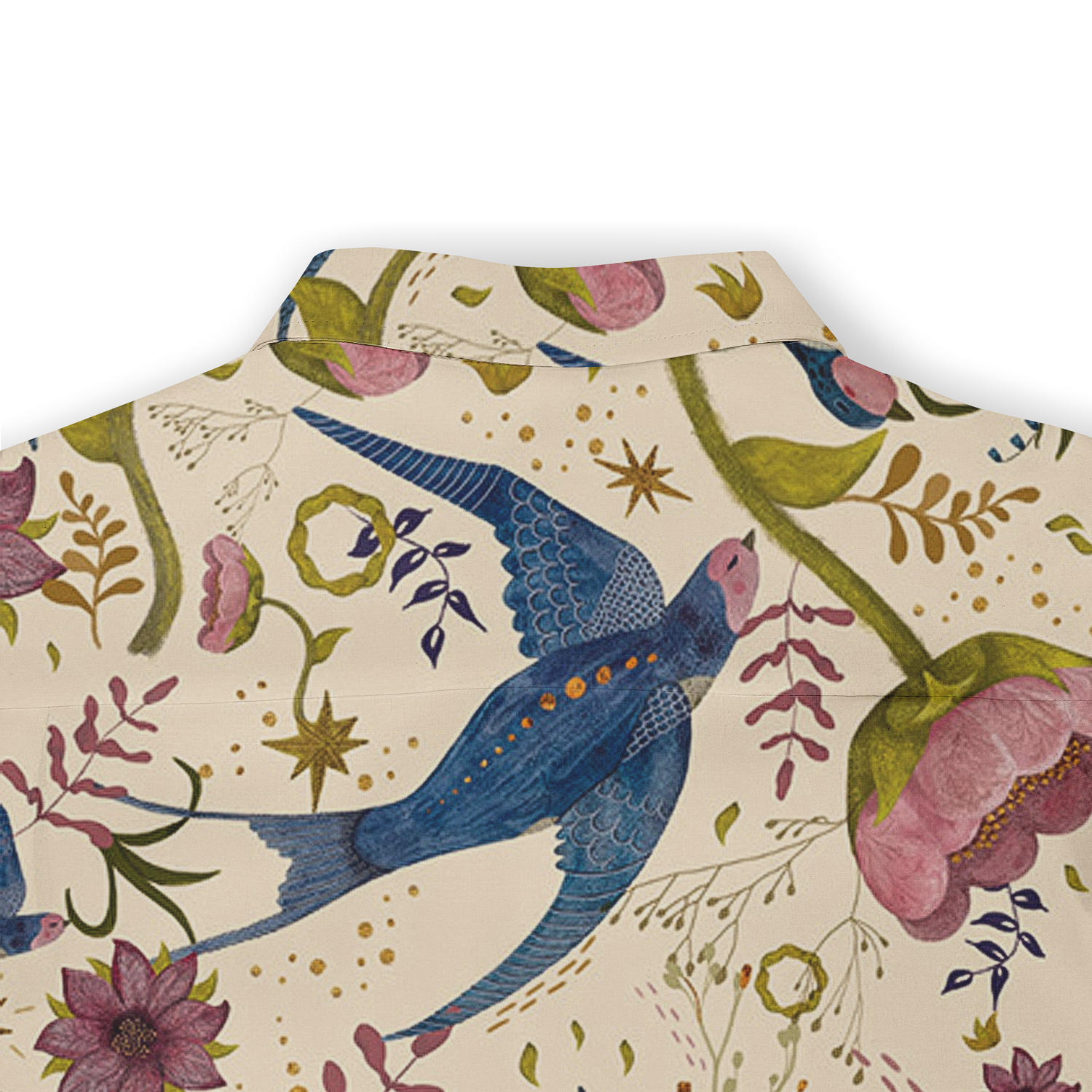 This is a close-up of the back of a shirt featuring a whimsical design with vibrant blue birds and pink flowers, set against a light beige background. The pattern includes floral elements and stars, contributing to the shirt’s playful and artistic style.